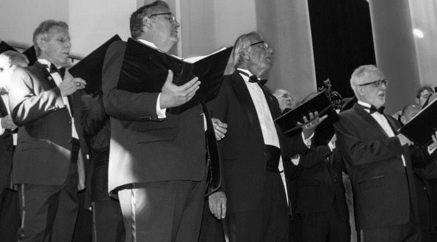 Members of the Orpheus Male Chorus of Phoenix performing in formal attire.