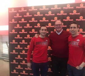 Mike Peterson standing with two men in Ohio State shirts at a Fiesta Bowl event.