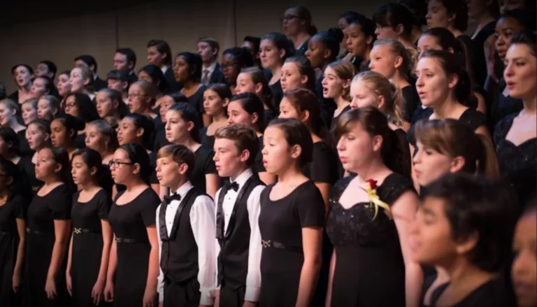 Student choir performing on stage as part of the Orpheus Male Chorus of Phoenix scholarship program for young singers.
