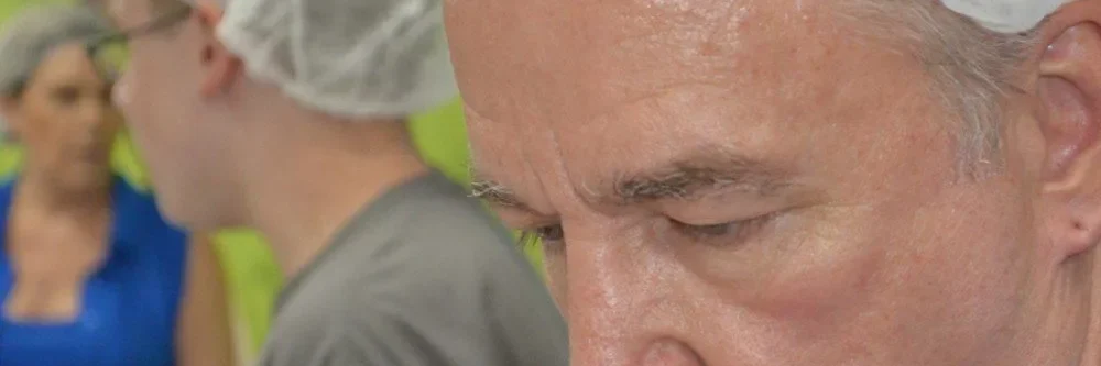 Volunteers carefully preparing food packages at a Feed My Starving Children charity event.