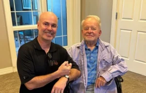 Wayne Grove seated on the right, next to another man.