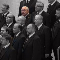 Bob Meier standing among fellow choir members in a formal group photo.
