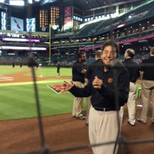 Michael Clark walking on a baseball field.
