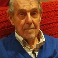 Ted Crow seated, wearing a blue sweater.