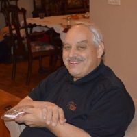 Bob Meier smiling while seated indoors.